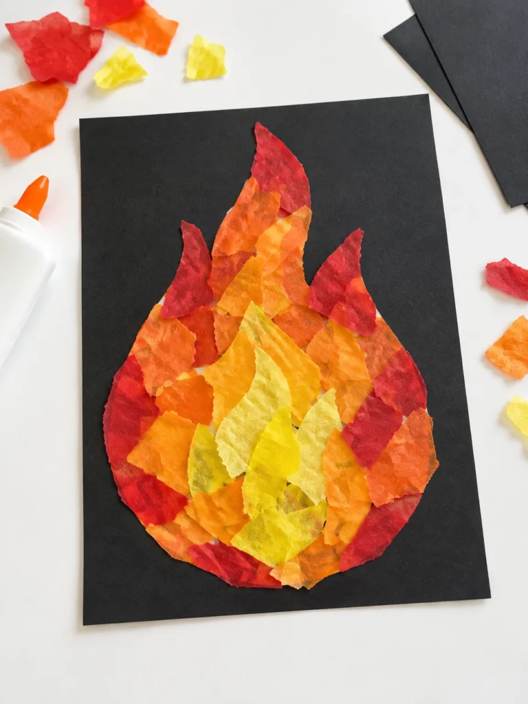 Preschool flame collage made from torn red, orange, and yellow tissue paper on black cardstock.